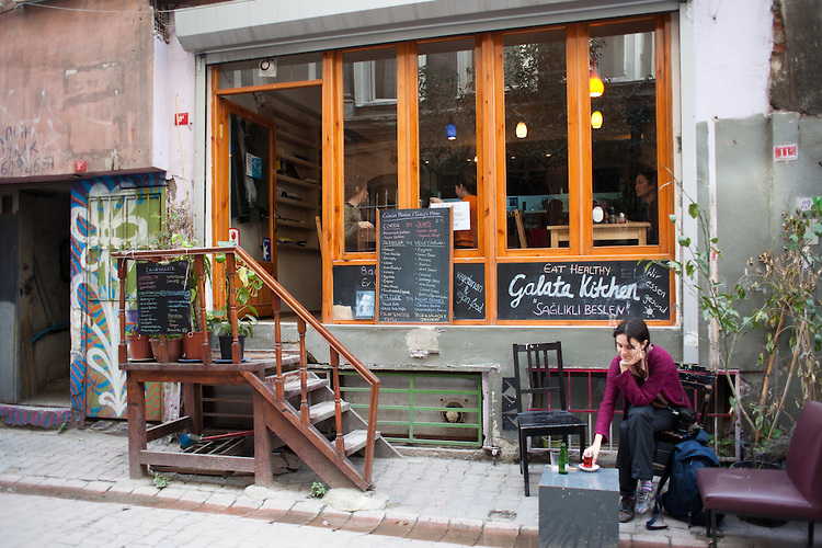 Ozge Sebzeci  drinks tea outside the Galata Kitchen, a hidden lunch spot in Karakoy near the Galata Tower.